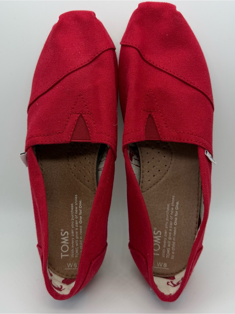 TOMS Women’s Classic Canvas Slip-Ons in Red. Women’s size 8.  Like new!